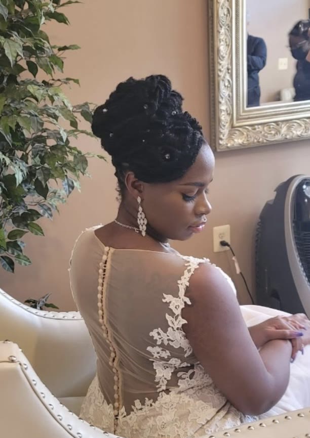 Bride in a lace gown with a sculpted updo, styled by Enigmatic